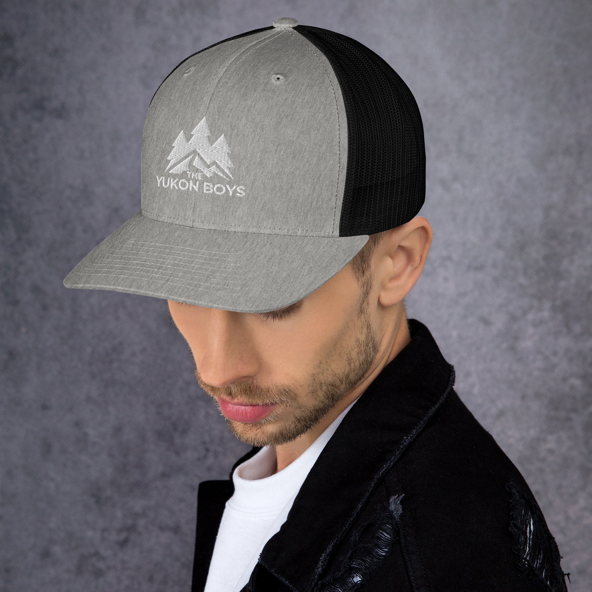 The Yukon Boys Trucker Cap in Heather Black, left side view